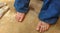 Dirty girl`s feet resting with flip-flops next to her after working in the garden.