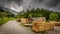 Dirty, gravel, path around Sawmill under Schneeberg with piles of wood