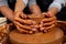 Dirty hands close up . romantic couple in love working together on potter wheel and sculpting clay pot,a bearded man and