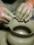 Dirty hands making pottery in clay