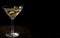 Dirty martini aperitif with olives in glass on a black background with space for text. Aperitif on a dark background. Generated AI