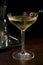 Dirty martini cocktail with olives in glass on a dark background. Aperitif on a black background. Generated AI