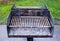 Dirty metal barbecue grill with ashes.