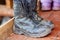 Dirty military or Hiking boots on wooden background