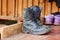 Dirty military or Hiking boots on wooden background