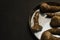 Dirty mushroom in a plate on a black background