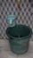 Dirty Plastic Bucket for water reservoir on a traditional bathroom with abstract cube wall pattern