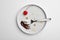 Dirty plate with food , fork and canned cherry on white background, top view
