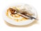 Dirty plate with fork and spoon on a light background. Spaghetti Bolognese leftover. Finished dinner