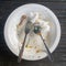 dirty plates that have been used to eat, leaving only spoons, forks, pieces of chicken bones and dirty tissue