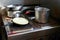 Dirty pots and pans are placed on a stainless steel electric stove on the galley on the ship