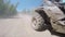 Dirty quadrobike dynamically riding on the offroad among grass and bushes