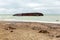 Dirty sandy beach in the remnants of garbage after the ship wreck.