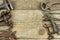 Dirty set of hand tools on a wooden background. Old rusty tools. Equipment for locksmith and metalworking shop.