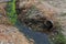 Dirty sewage along with sewage in an open ditch along the street. Dirty drainage, an open sewer collector here with toxic algae. E