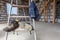 Dirty shoes and T-shirt with dust footprint of worker on the stair of ladder