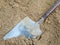 Dirty shovel on sand