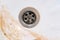 Dirty sink drain mesh, hole with limescale or lime scale and rust on it close up, dirty rusty bathroom washbowl