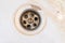 Dirty sink drain mesh, hole with limescale or lime scale and rust on it close up, dirty rusty bathroom washbowl