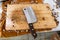 Dirty stainless steel cleaver on wooden chopping board