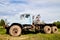 Dirty truck on a country green grass in a sunny summer day with blue sky