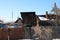 Dirty unkempt wooden house in the village behind an iron fence