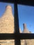 Dirty window onto bottle kilns.