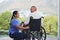 Disability healthcare, doctor and senior patient with support from medical nurse in a wheelchair. Disabled elderly man