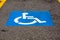 Disability symbol painted on the floor at parking lot