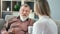 Disabled 80s father grandfather talking to young adult daughter granddaughter enjoying friendship