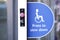 Disabled accessible push button sign at shop entrance