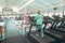 Disabled active senior woman exercising on treadmill in fitness studio