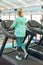 Disabled active senior woman exercising on treadmill in fitness studio