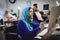 Disabled arab woman in wheelchair working in office. Woman is working on desktop computer.