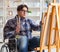 Disabled artist painting picture in studio