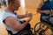 a disabled basketball player puts on a corset and bandages on his arms and fingers in preparation for a game in the