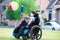 Disabled boy hitting ball with bat at park