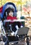 Disabled boy in medical wheelchair at park