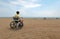 Disabled boy sitting in a wheelchair looks at the sea