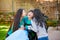 Disabled boy in wheelchair laughing with teen sister on patio