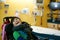 Disabled boy in wheelchair smiling next to hospital bed