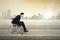 Disabled businessman pushing wheelchair outdoors