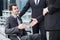 Disabled businessman shaking hand with business partners