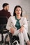 Disabled businesswoman looking at camera while sitting in wheelchair in office