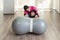 disabled child and physiotherapist on a Peanut Gym Ball doing balance exercises. pandemic mask protection