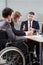 Disabled employee next to conference table