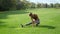 Disabled fit woman stretching legs in park. Lady preparing for workout outdoors