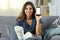 Disabled girl with plaster foot showing phone screen