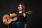 Disabled girl playing guitar.