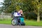 Disabled girl in a wheelchair relaxing outside